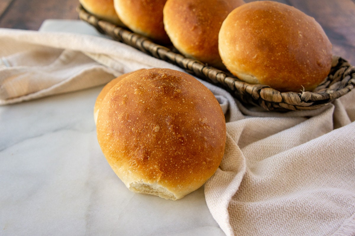 homemade burger buns on a table and in a basket