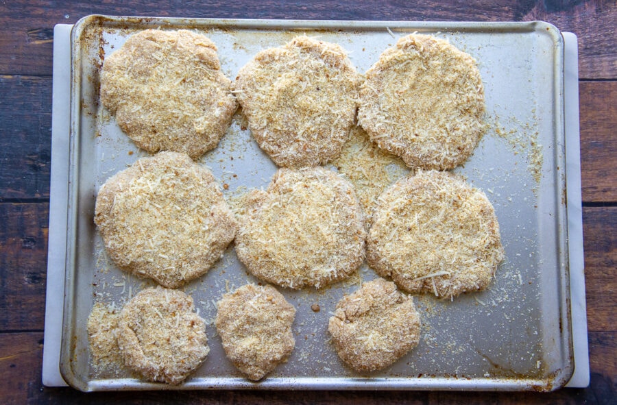 chicken patties coated with breadcrumbs and parmesan ready to be cooked.