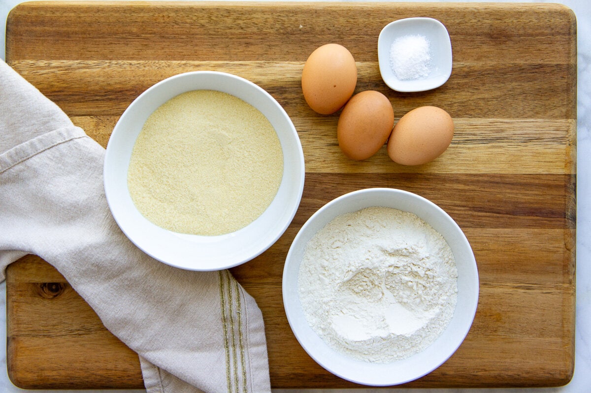 bowls of flour, eggs, and salt to make homemade pasta dough.