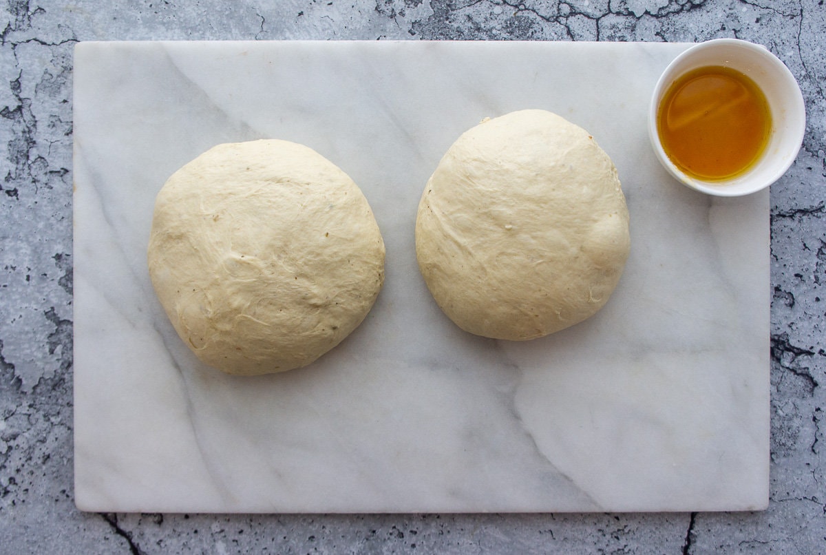 two balls of pizza dough ready to shape.