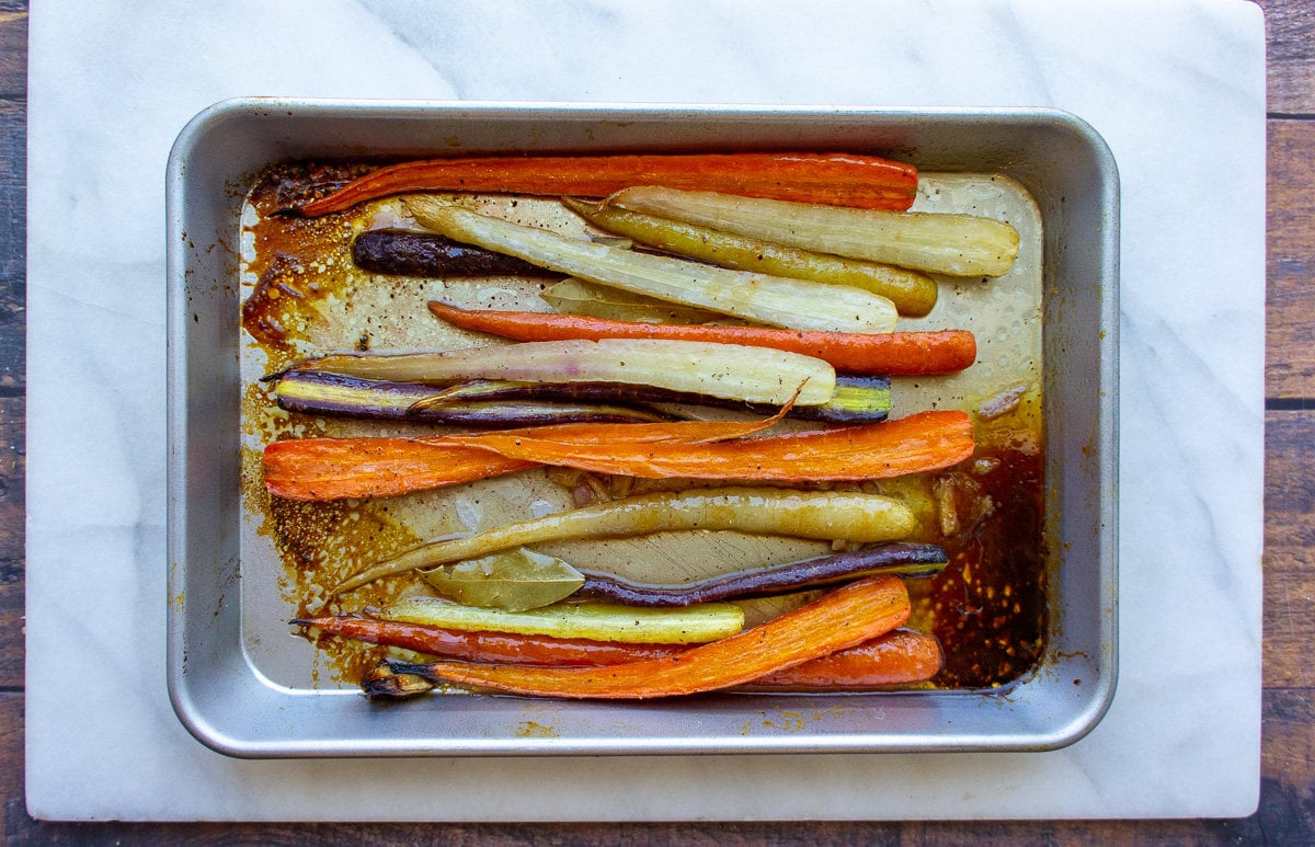 a metal pan with roasted rainbow carrots in it.