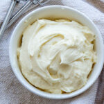 a bowl of maple frosting on a towel.
