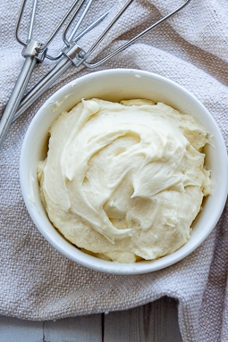 a bowl of maple frosting on a towel.
