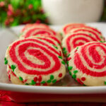 a plate of sugar cookies with red and white swirls.
