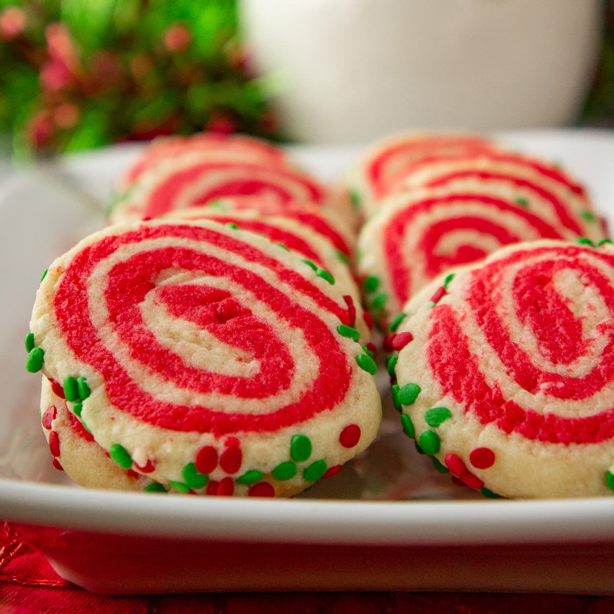 a platter of sugar cookies swirled with red and white.
