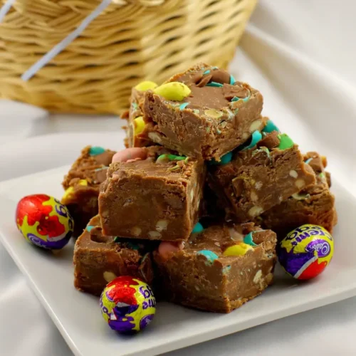 A plate of chocolate fudge filled with Easter egg creme candies.