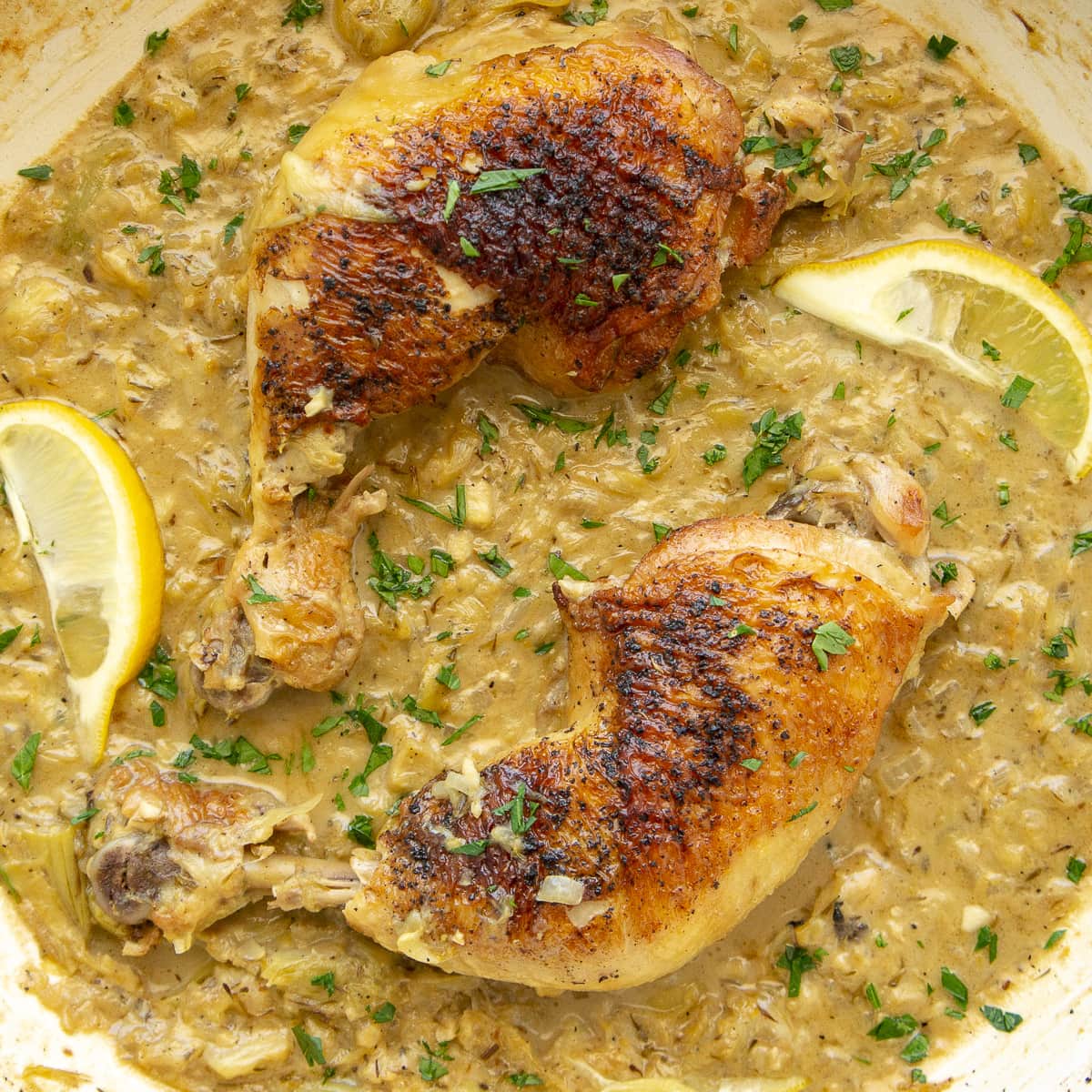 a pan of lemon chicken in a creamy sauce.