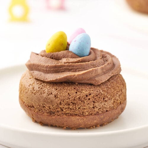 a nutella chocolate donut with frosting and easter eggs on top.