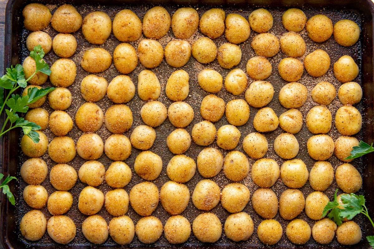 baby potatoes cut in half and arrange cut side down on a baking sheet.