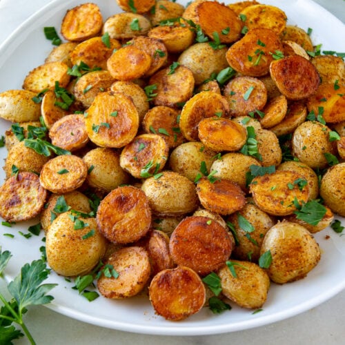 a platter of baby potatoes cut in half and roasted until golden.