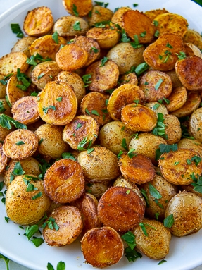 crispy baby potatoes with chopped parsley sprinkled on top.