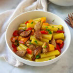a bowl of pepper and sausage pasta.