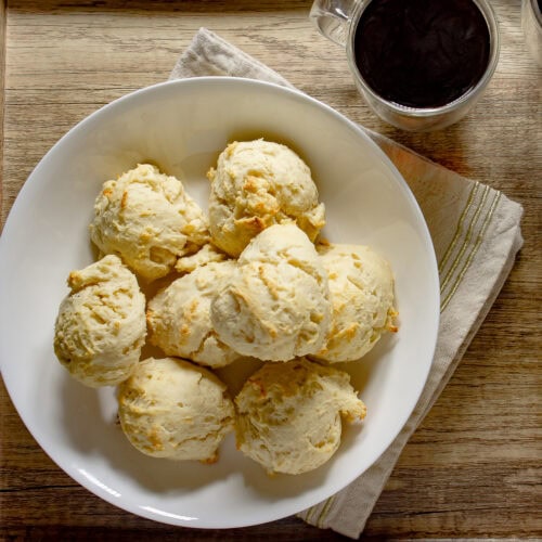 a white bowl of baked no-knead biscuits.