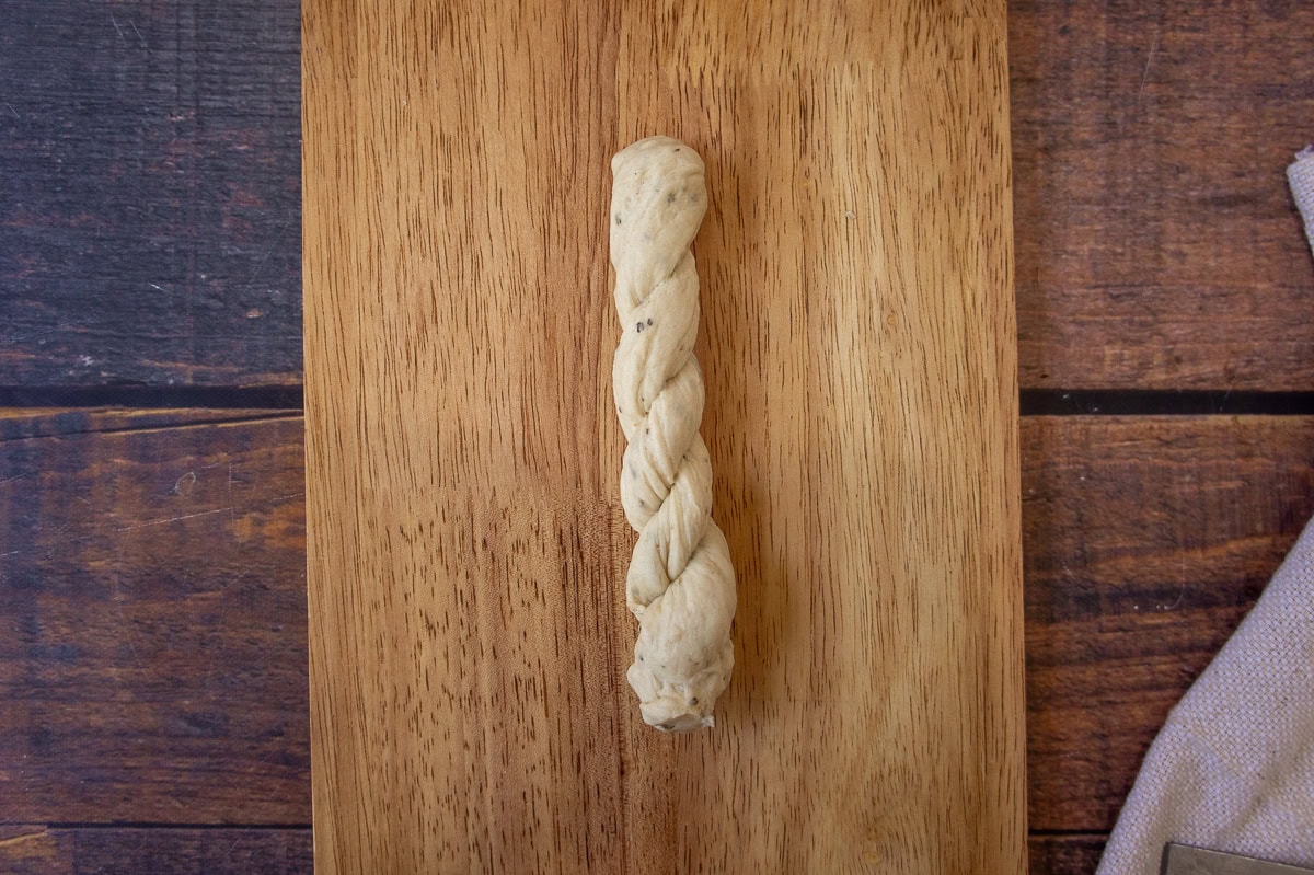 Two ropes of bread dough twisted together to make a twisted breadstick.