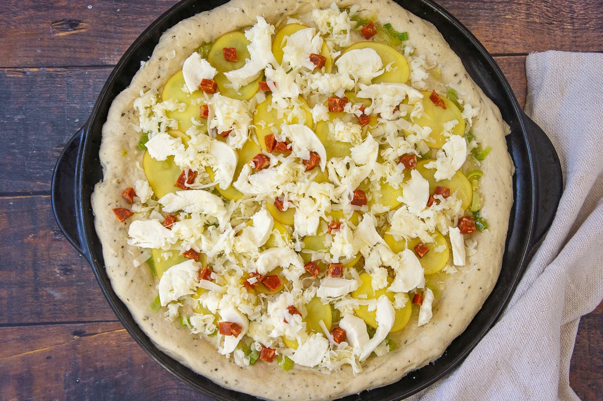 a pizza with potato, cheese, leeks, and linguica.
